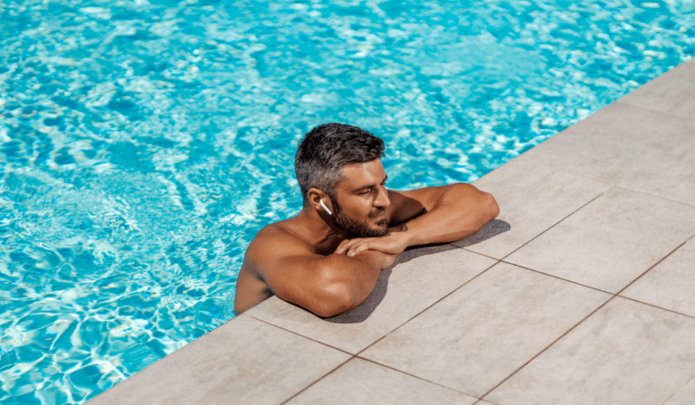 man swimming with waterproof earbuds